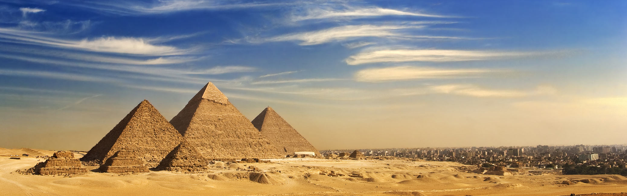 Egypt river cruise holiday featuring the Pyramids of Giza in Cairo under clear blue skies, showcasing ancient Egyptian landmarks.