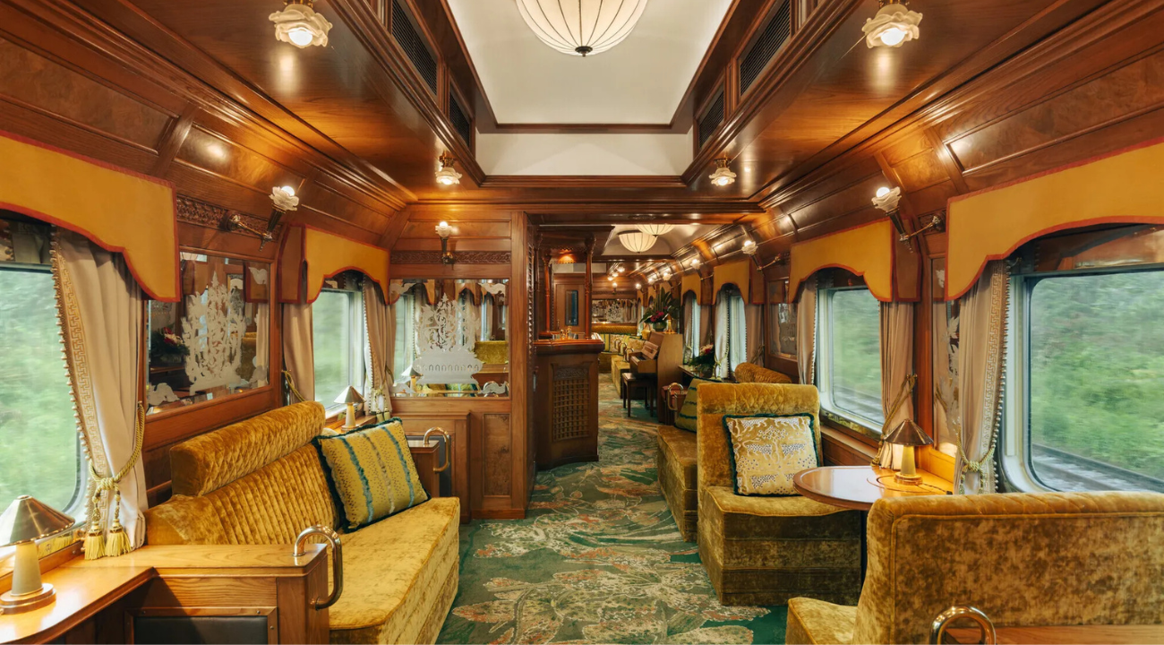 The elegant Piano Bar car on the Eastern & Oriental Express with wood panelling and sophisticated seating.