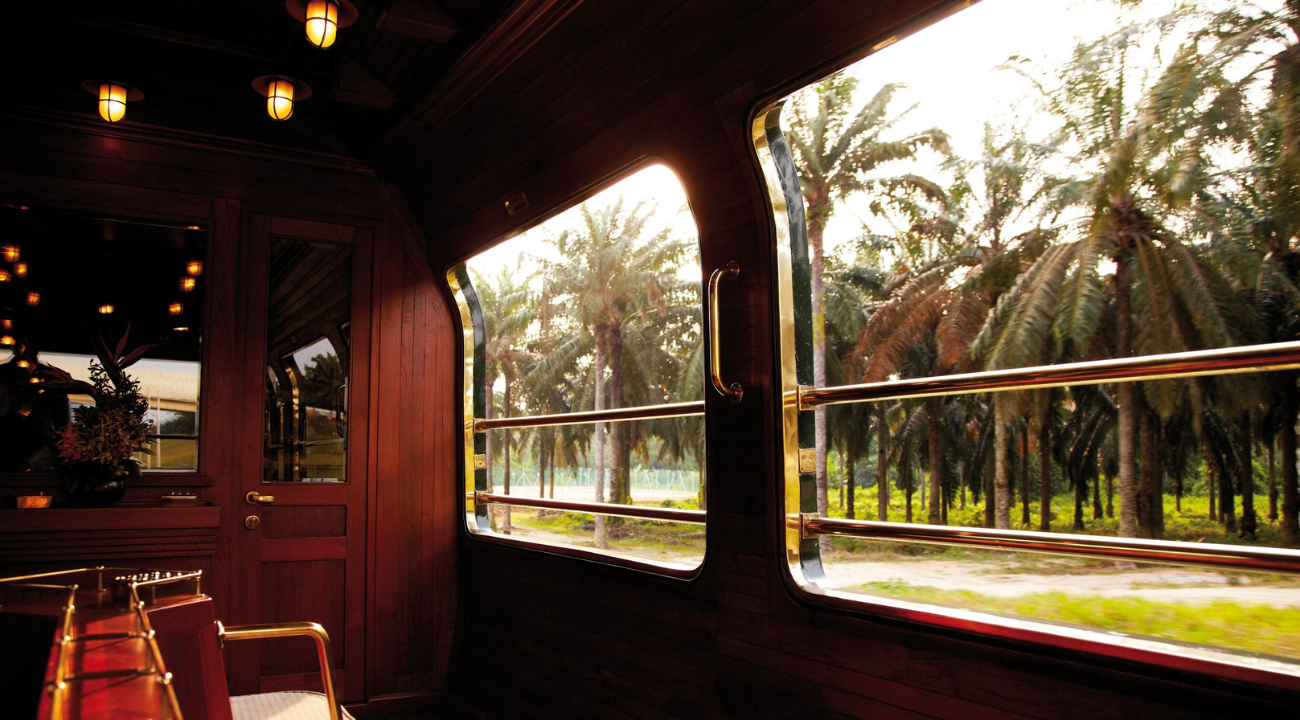 The open-air observation car at the rear of the Eastern & Oriental Express showing panoramic views of the jungle.