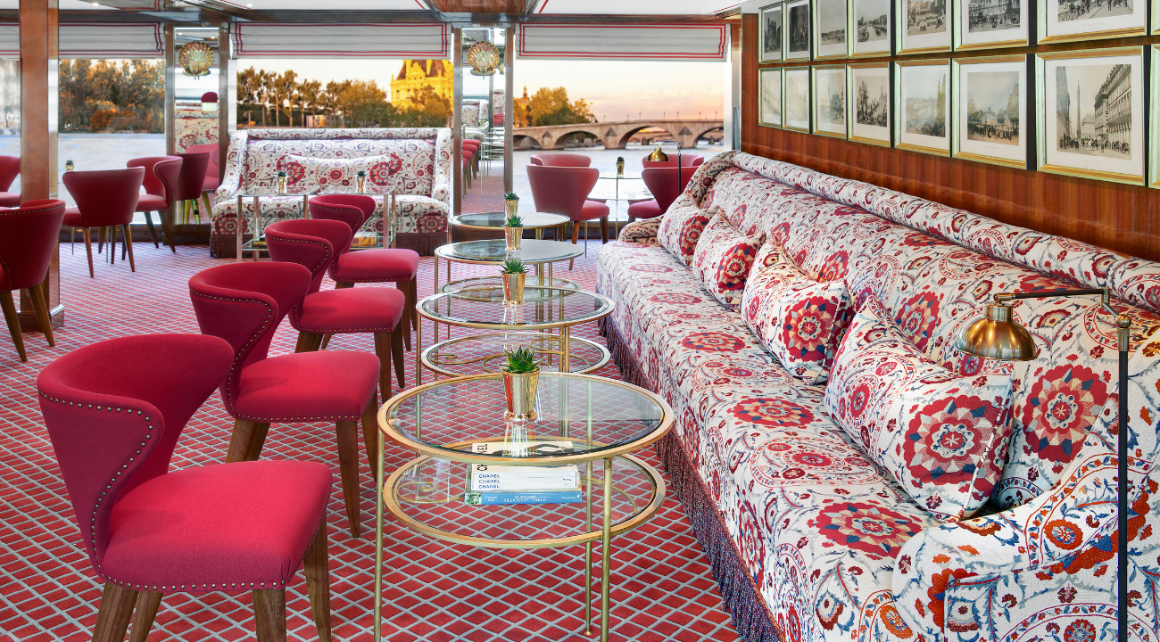 The elegant Salon Toulouse lounge on the S.S. Joie de Vivre featuring 20th-century Parisian chic decor.
