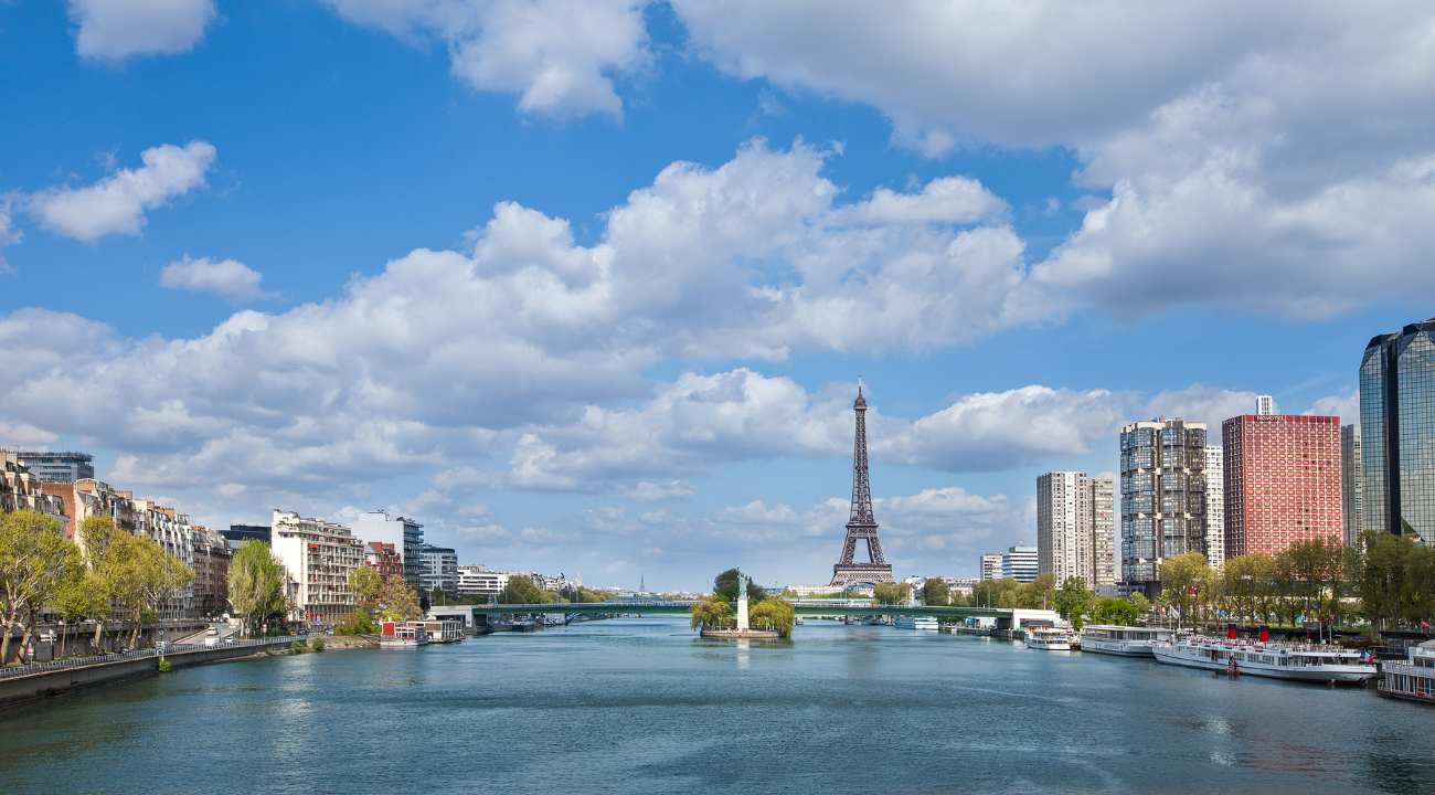 Panoramic view of the River Seine in Paris with historic bridges and city landmarks.