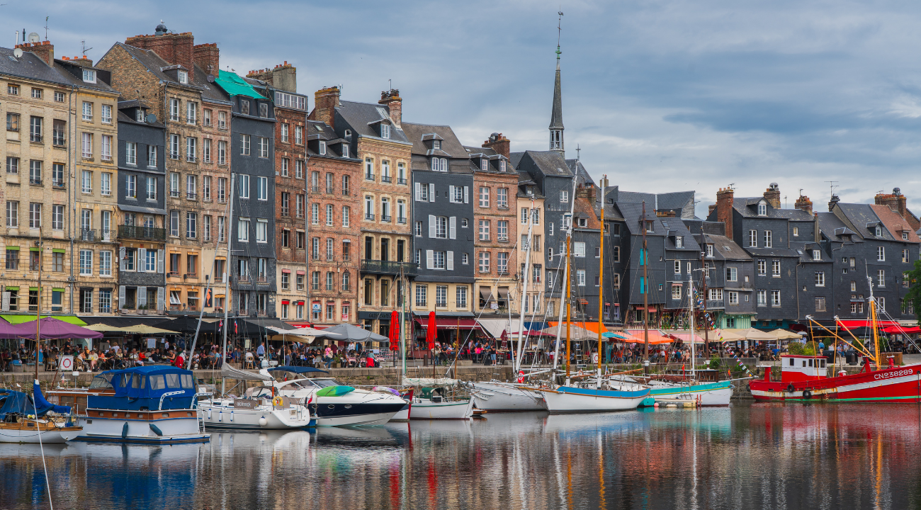 Colourful 17th-century slate-fronted houses lining the historic harbour of Honfleur.