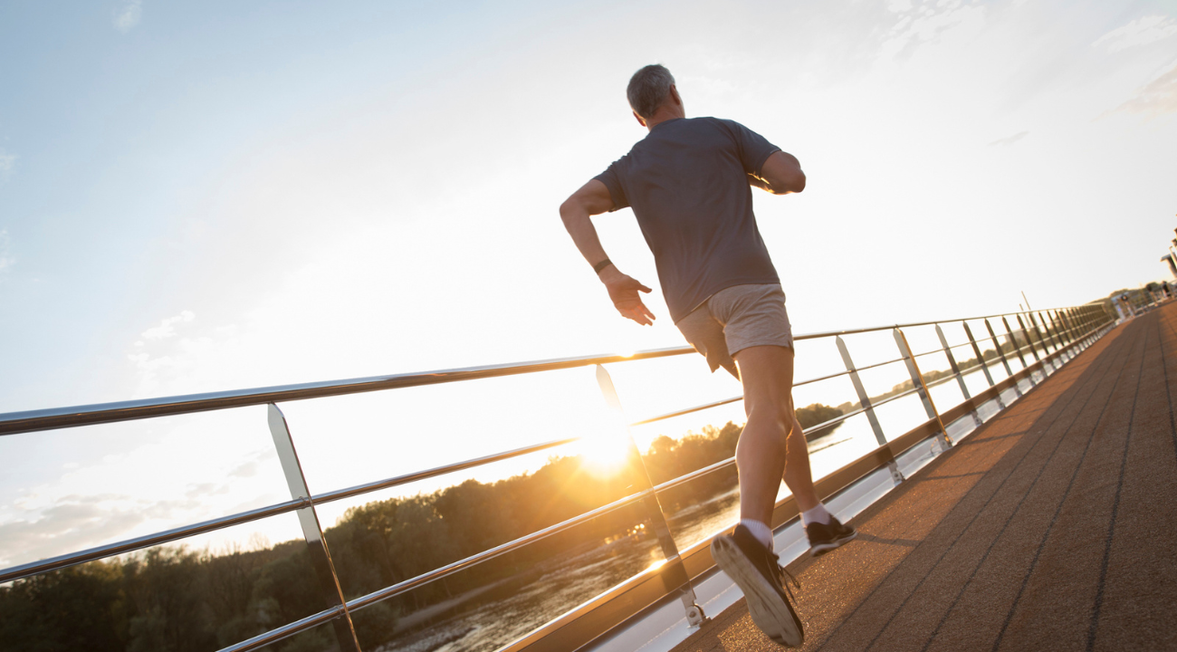 A guest enjoying a morning jog on the Sun Deck of the S.S. Joie de Vivre with river views.