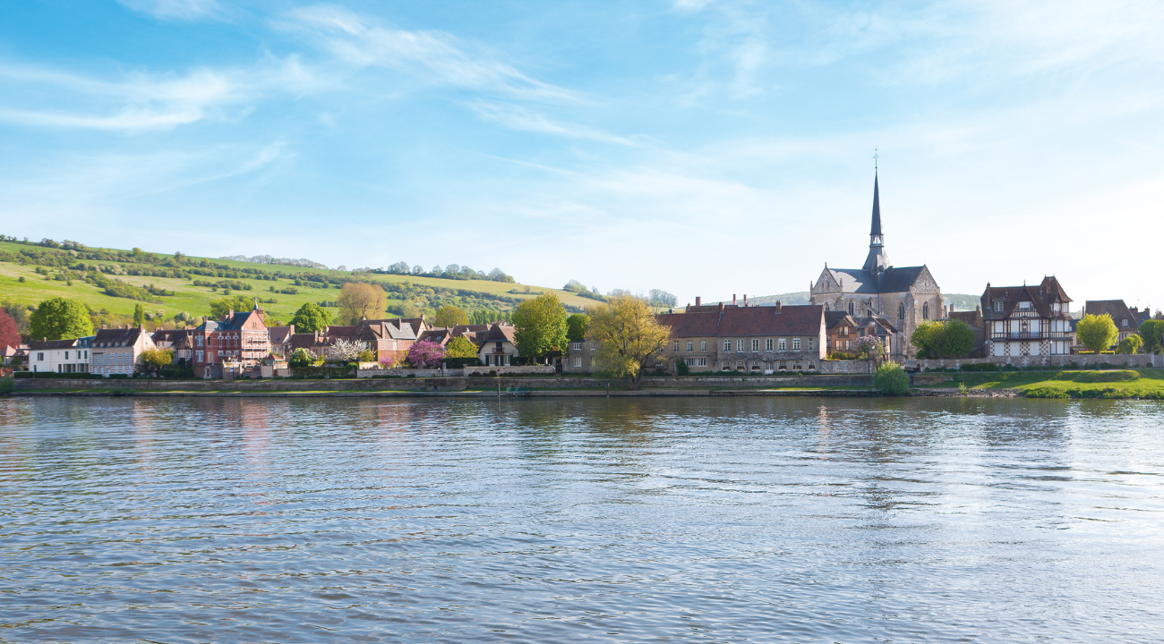 A charming riverside town in Normandy with traditional half-timbered buildings and stone bridges on the Paris and Normandy river cruise.