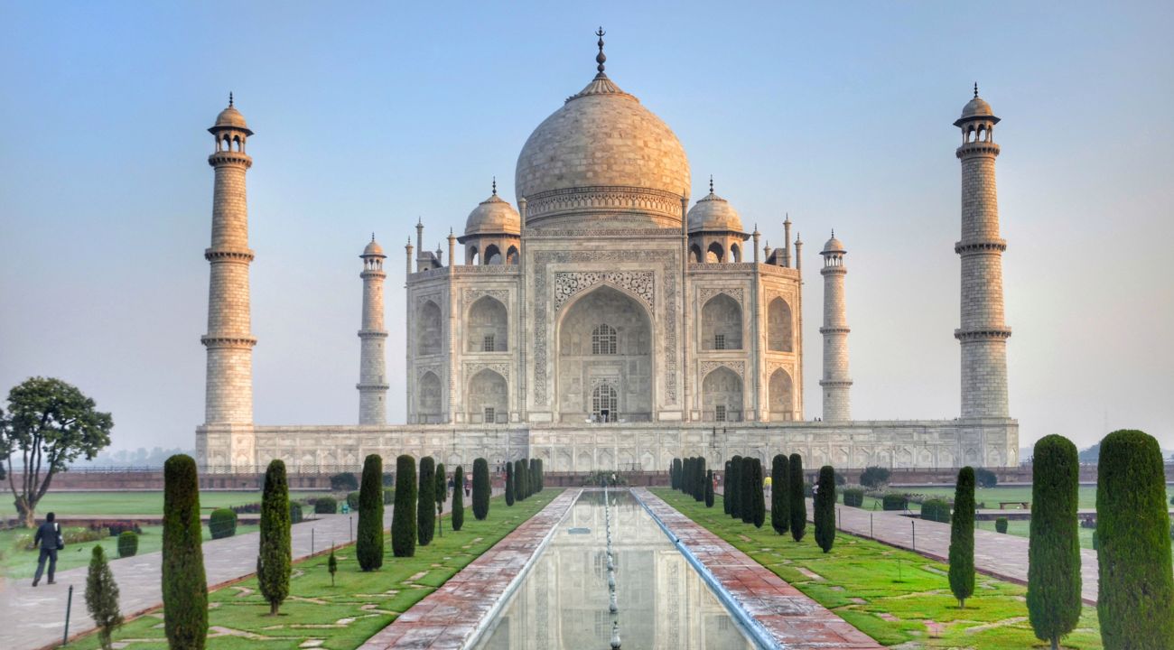 Visitors admiring the Taj Mahal, highlighting the choice between escorted tours and independent travel