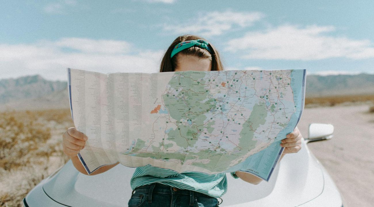 Traveller studying a map in a city, navigating an escorted tours vs independent travel
