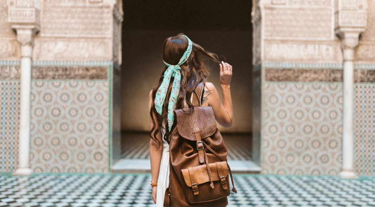 Female traveller walking through a city, enjoying sightseeing and independent exploration
