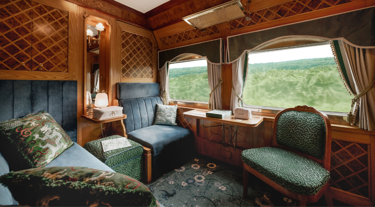 Luxurious interior of an Eastern & Oriental Express carriage featuring cherry wood panelling and marquetry.