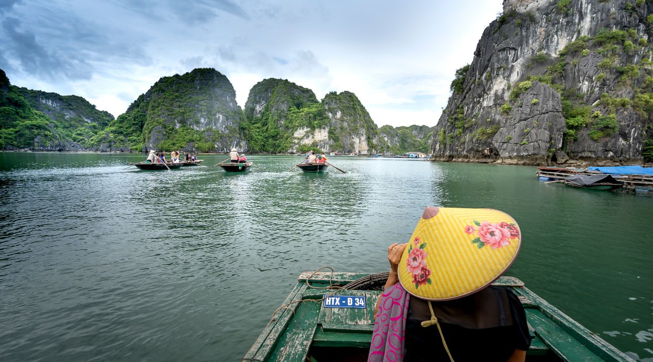 Traditional boats in Ha Long Bay, Vietnam surrounded by limestone islands