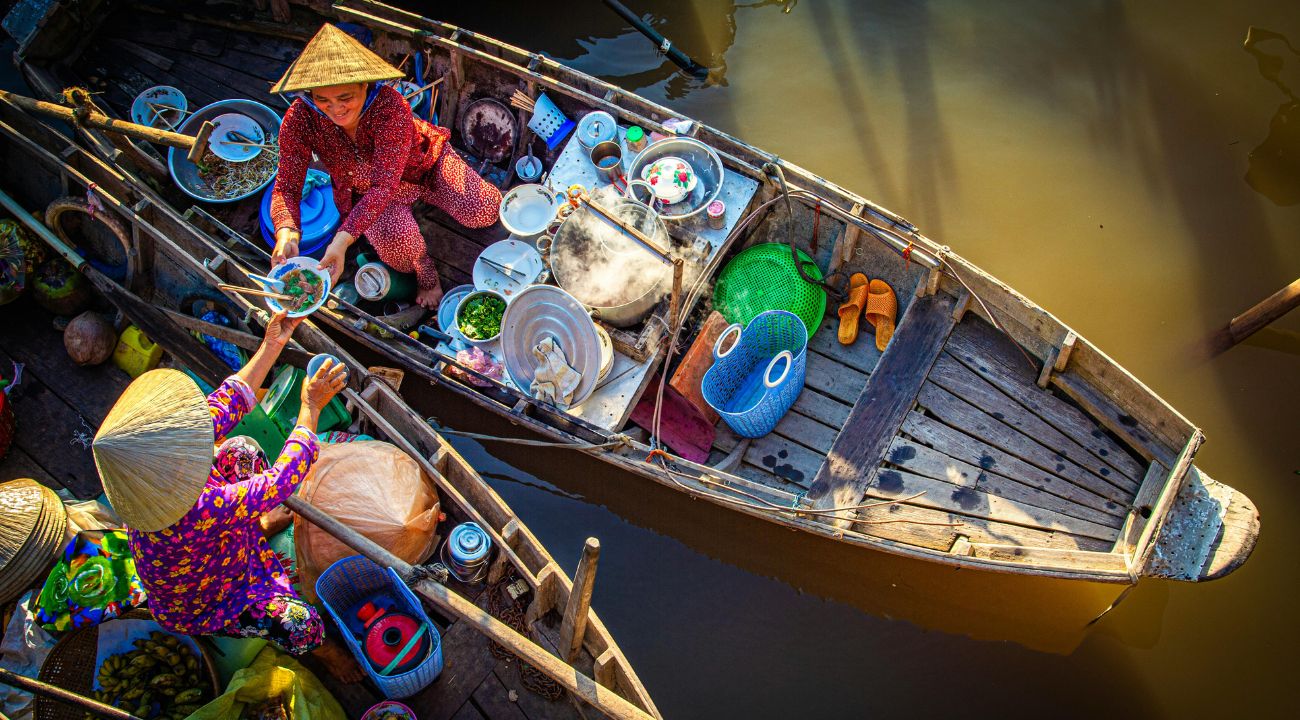 Floating market with boats selling goods on a river in Southeast Asia