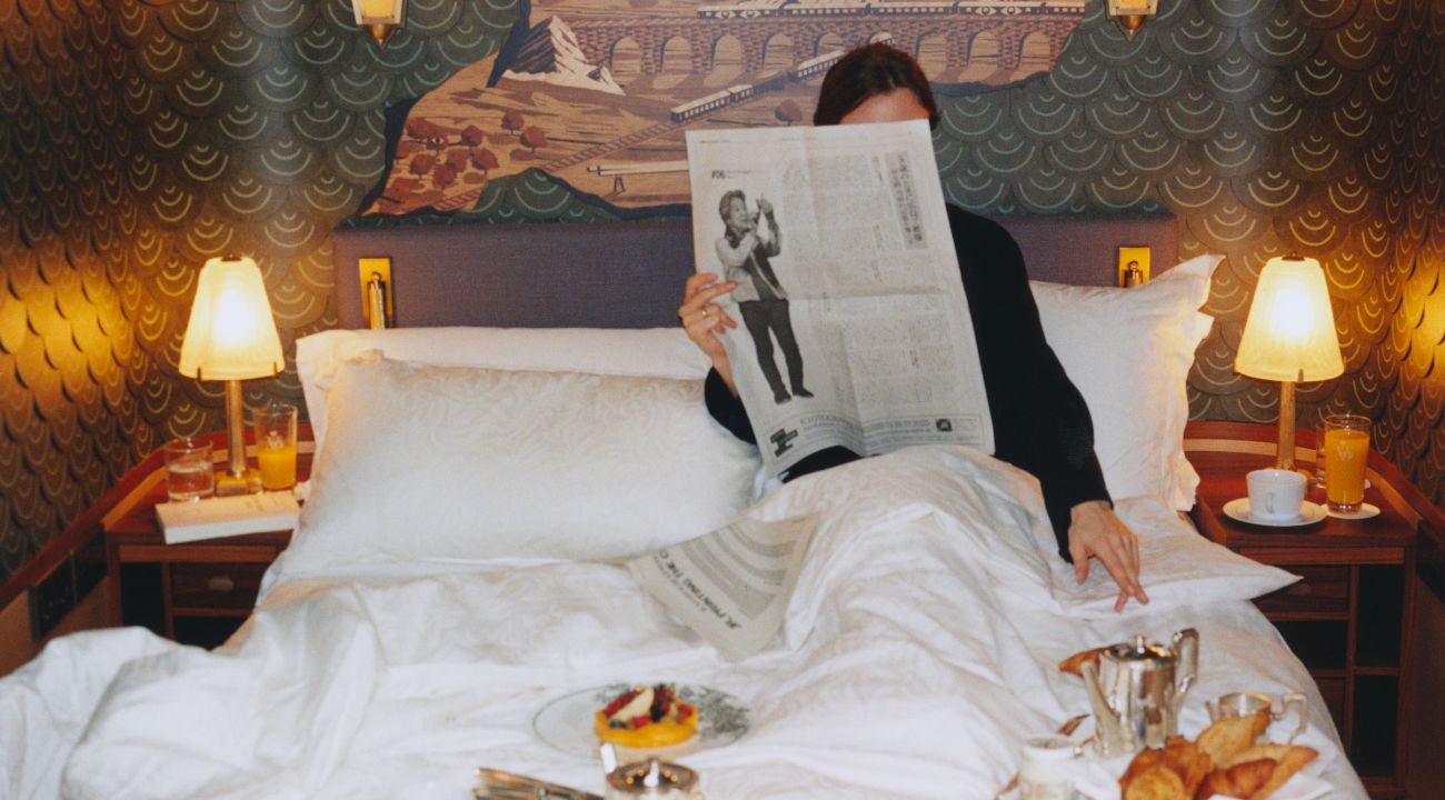 Guests enjoying breakfast in bed inside a luxury train travel