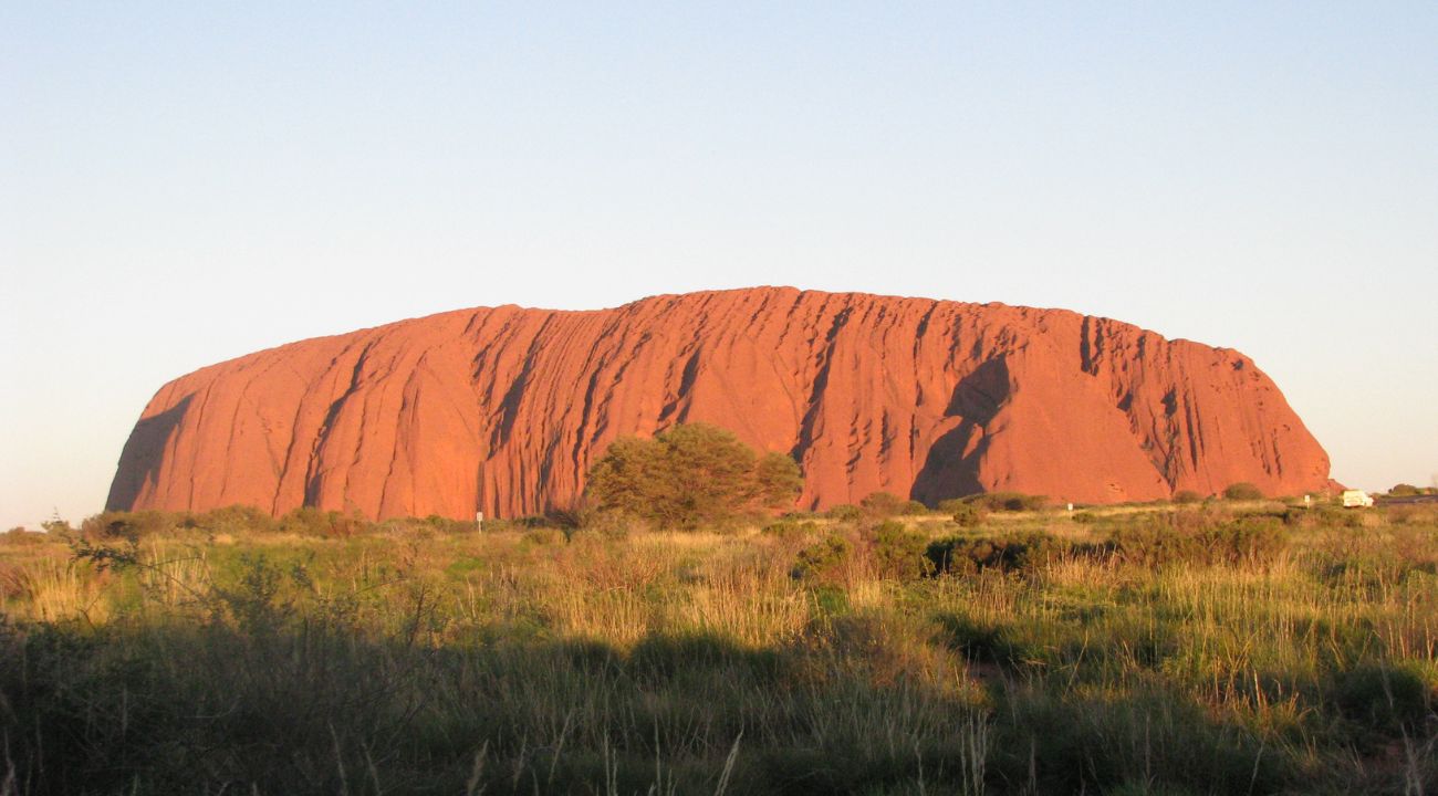 Uluru in Australia at sunset, one of the best destinations for touring holidays in Australia