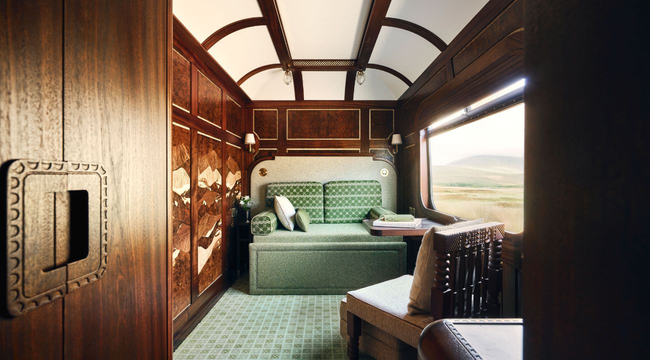 Double luxury train cabins during daytime seating configuration on board a sleeper train