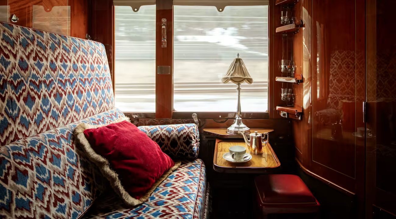 Train cabin arranged as daytime seating area with window views