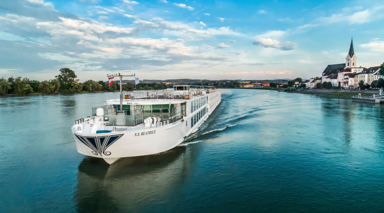 Luxury river cruise ship sailing along a European river through scenic countryside