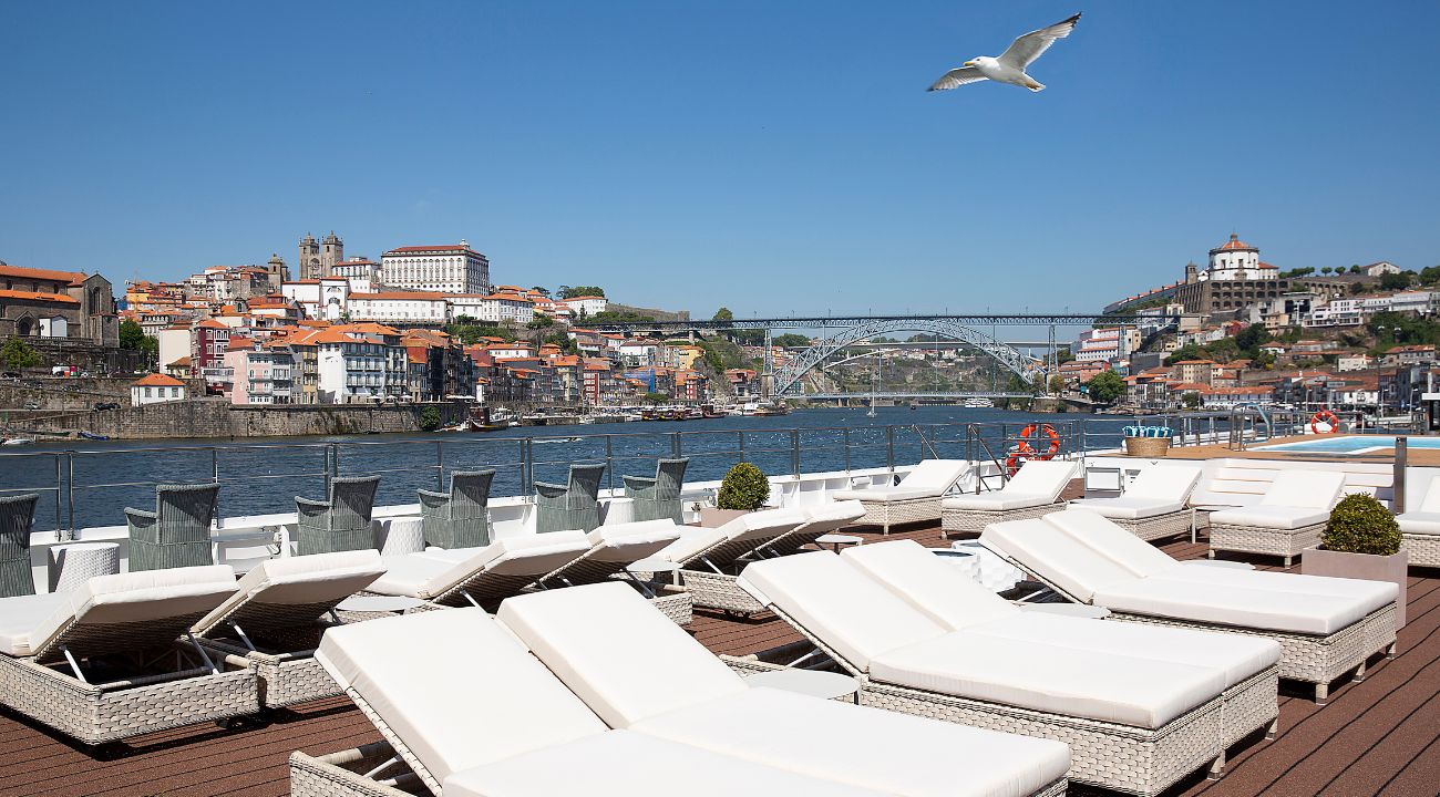 Sundeck of a river cruise ship overlooking the Douro River in Porto, Portugal with city and vineyard views