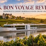 S.S. Bon Voyage luxury Bordeaux river cruise ship sailing past vineyards and château at sunset in France